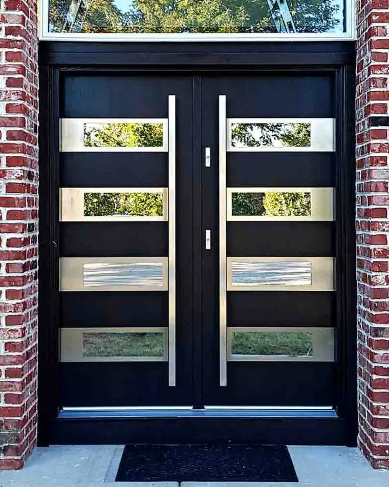 Main door in a double door style Main door in a double door style with bar handles, glass frame above and reflective glass incorporated