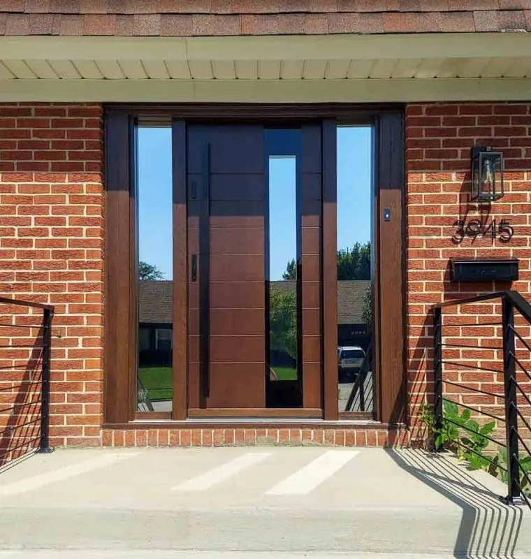 Main door Main door of a house made of wood with two sidelights having reflective glass, a metal bar handle and two locksets