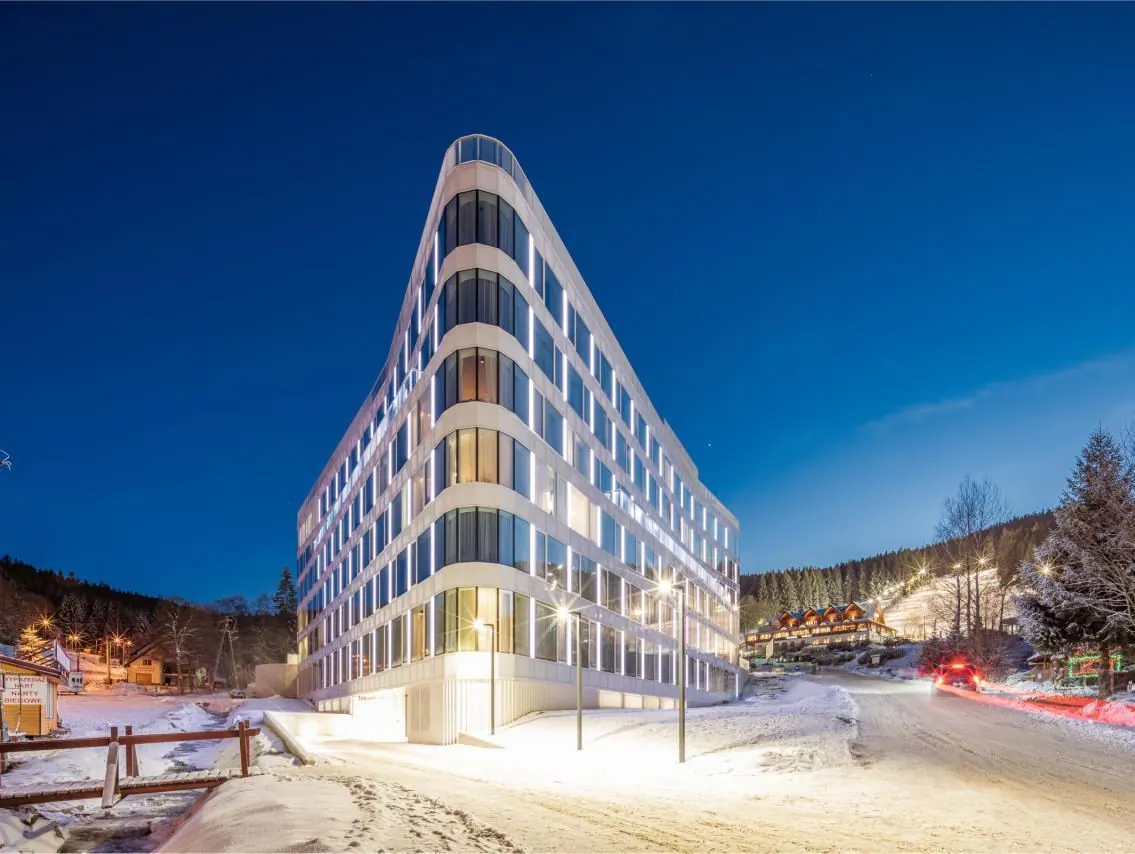 A white residential building in the evening