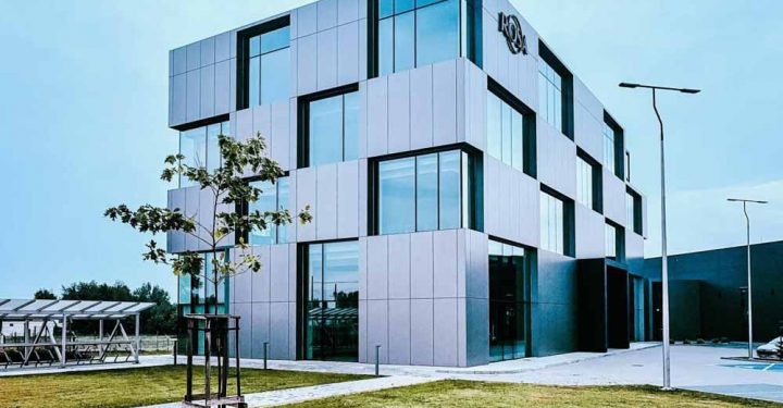An office building, A modern architectural design of a building with four floors, innovative windows that are matching with the unique design of the commercial property.